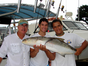Happy family with a large gamefish from their fishing trip.